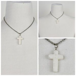 White granite cross on silver chain.